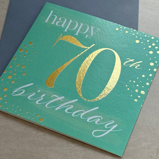 Green birthday card with gold text for a 70th birthday on a gray background