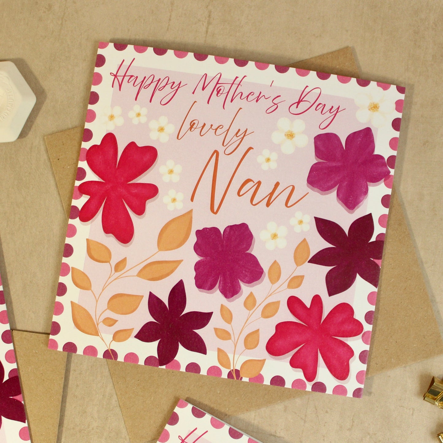 Greeting card with floral design and 'Happy Mother's Day lovely Nan' text on a beige background.
