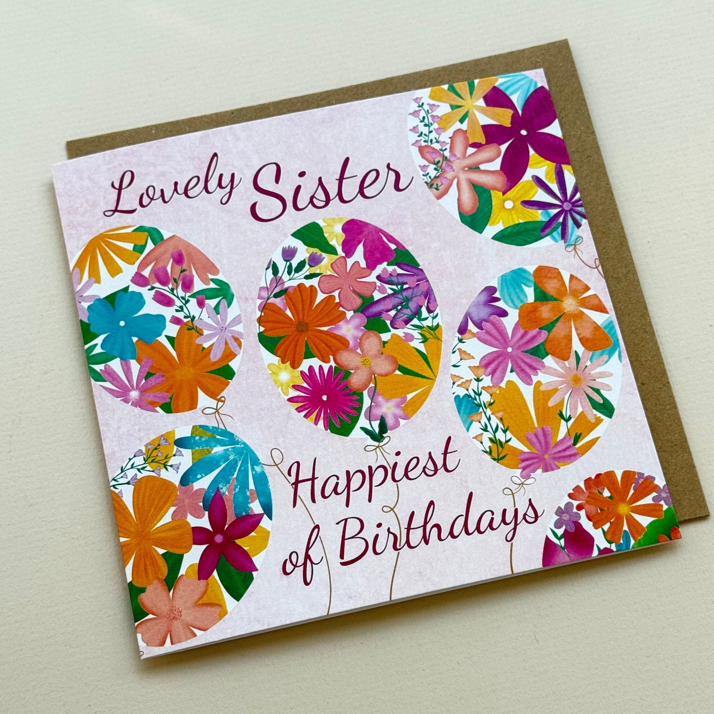 Greeting card with colorful floral design and text on a plain background