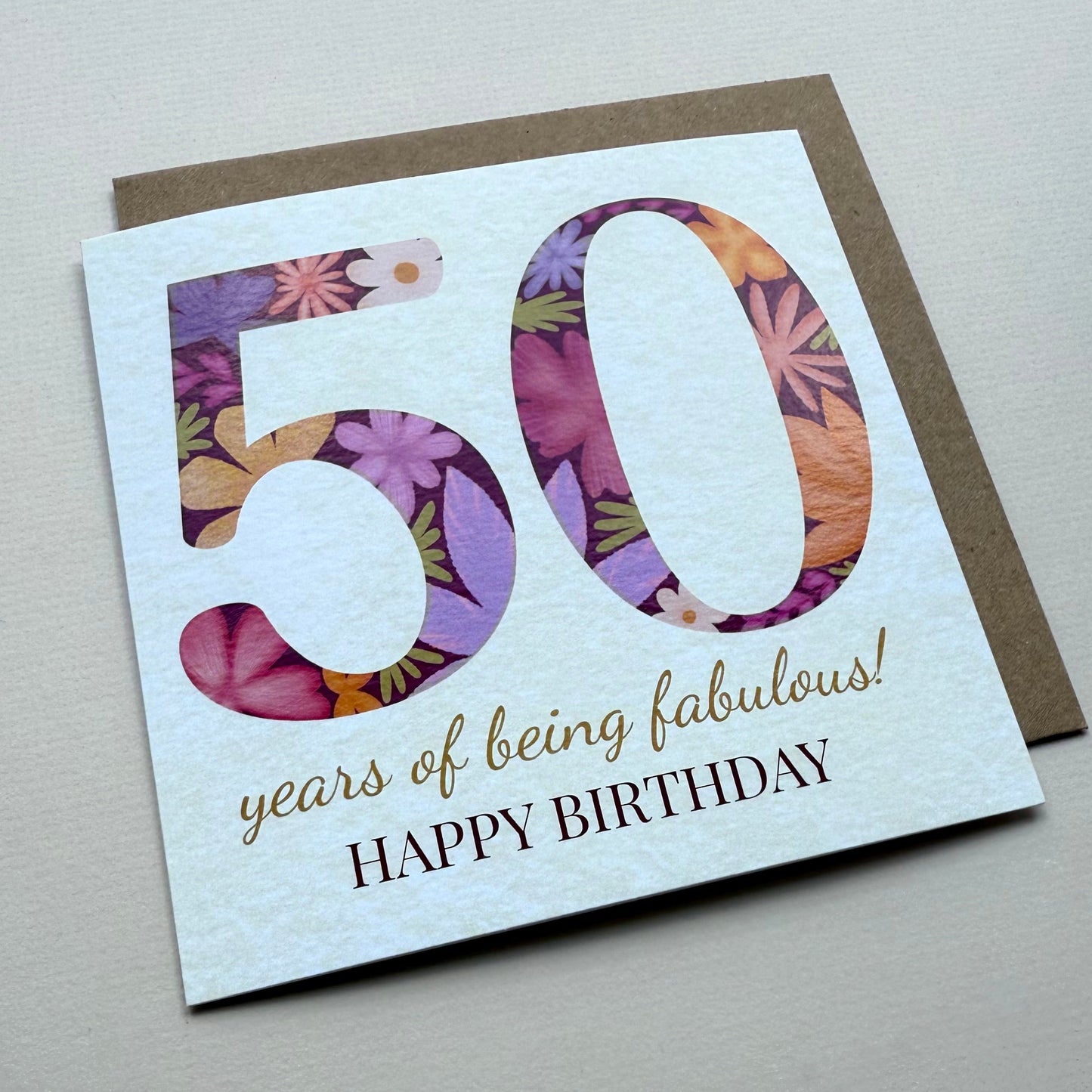 50th birthday card with floral design and text on a gray background