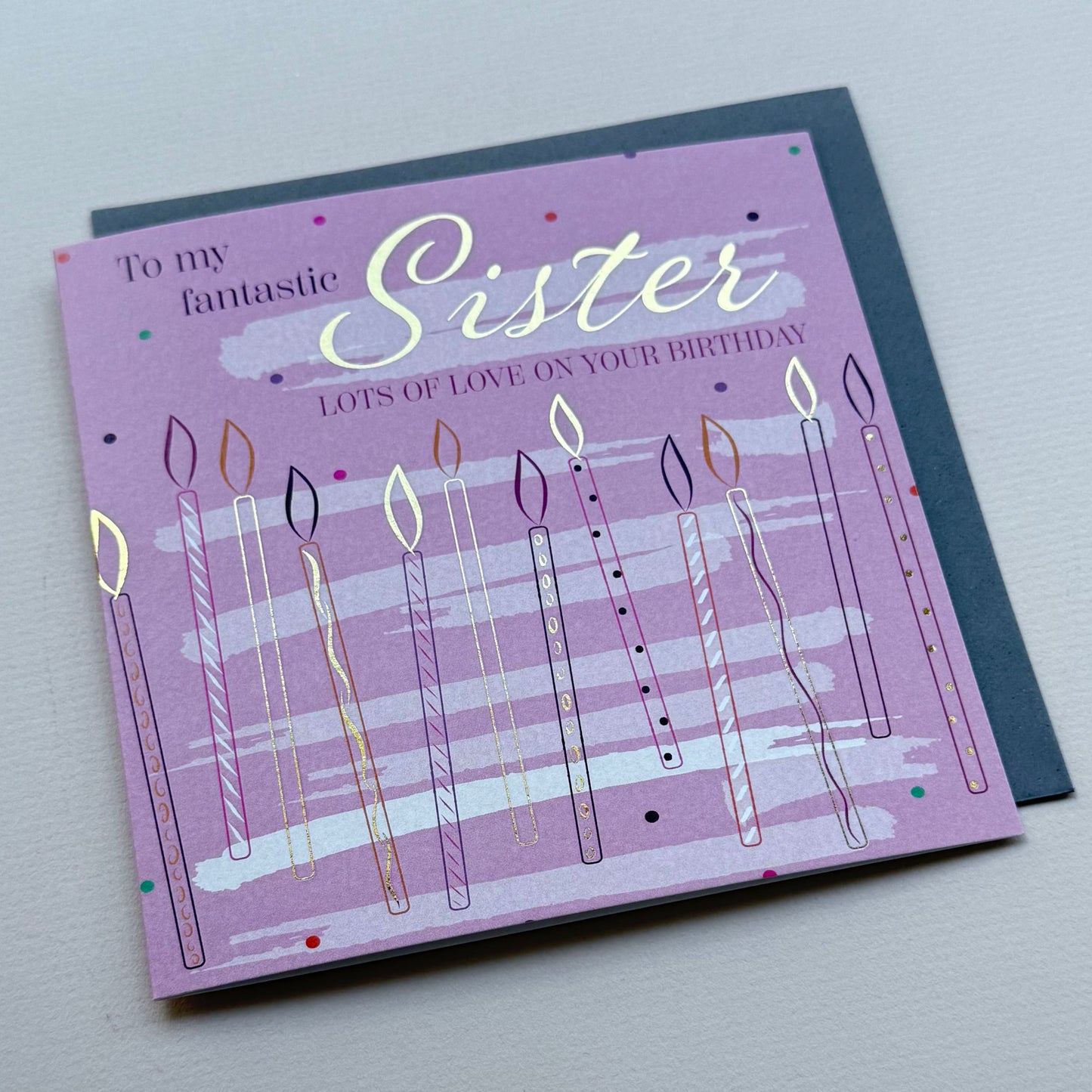 Greeting card for a sister with candles and text on a purple background
