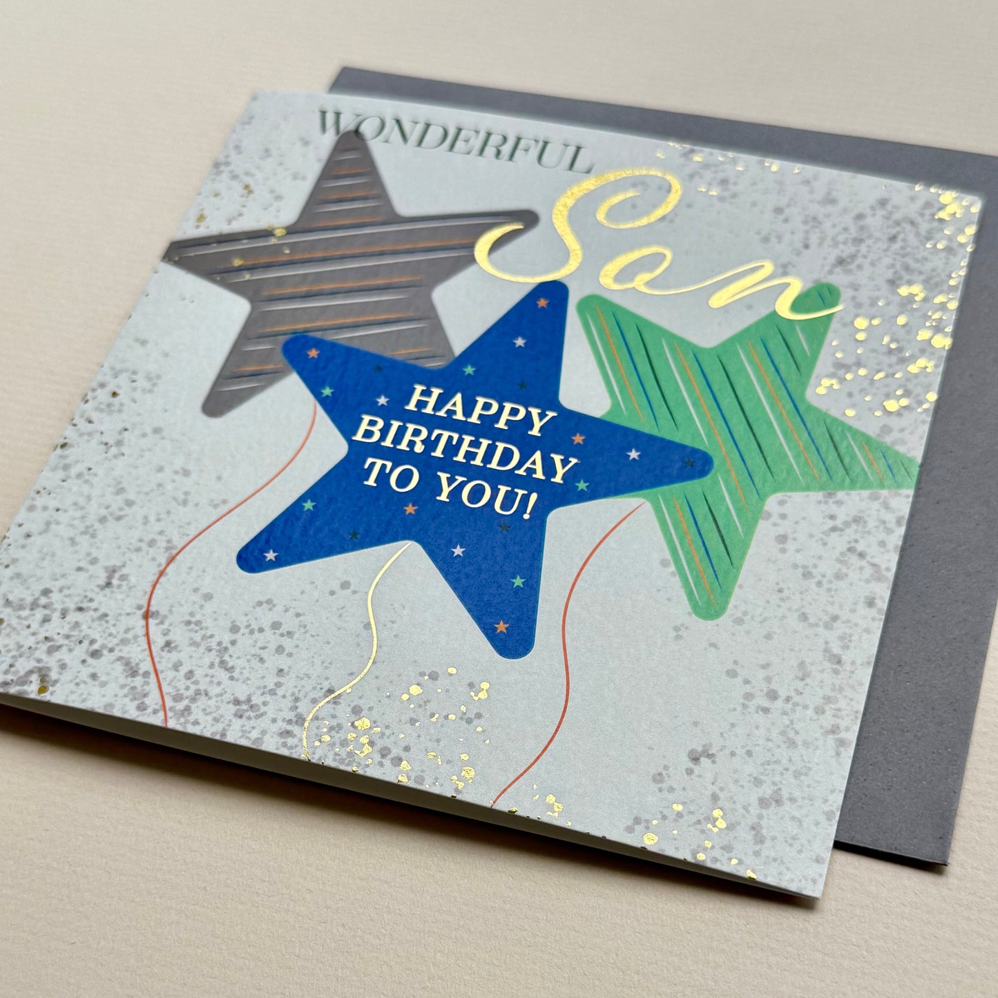 Birthday card for a wonderful son with stars and text on a gray background