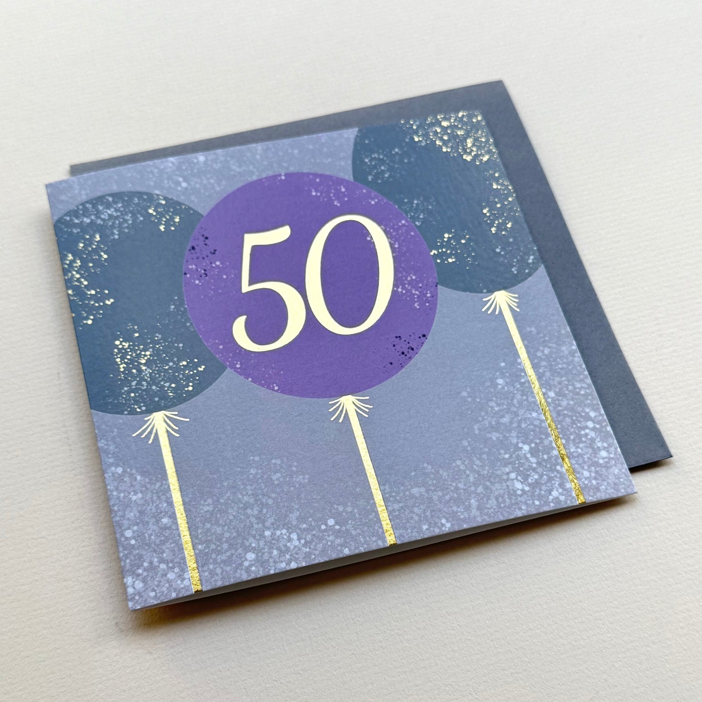 Greeting card with number 50 and balloons on a blue background
