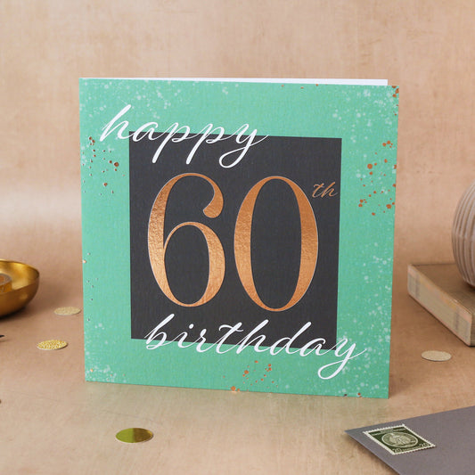 60th birthday card with gold text on a textured surface