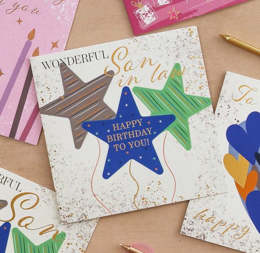 Birthday card with colorful stars on a wooden surface
