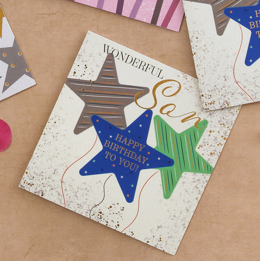 Birthday card with star designs on a brown surface