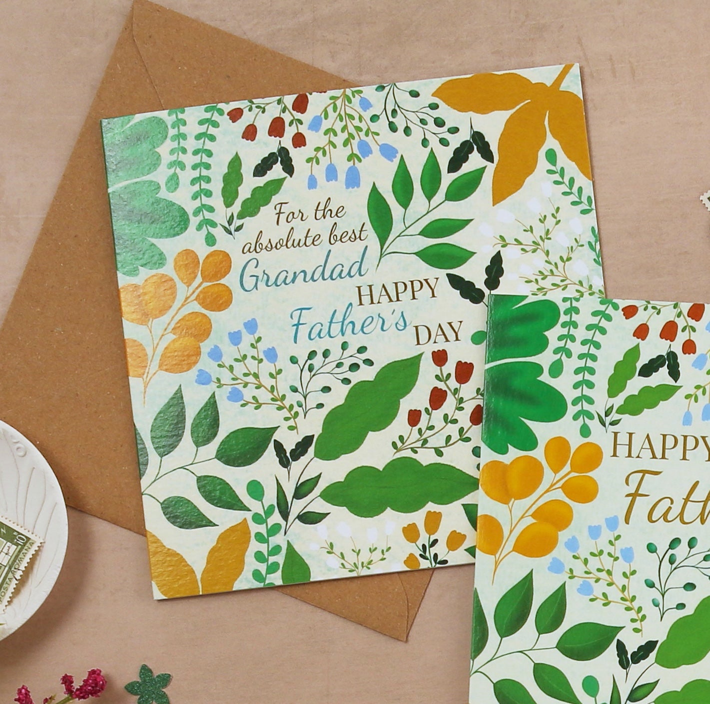 Father's Day card with floral design and envelope on a brown background