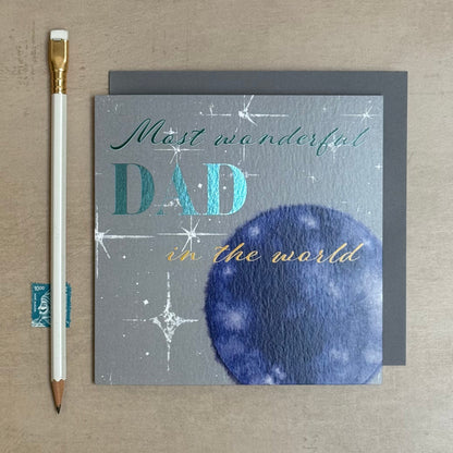 Greeting card for Father's Day with 'Most wonderful Dad in the world' text on a textured surface.