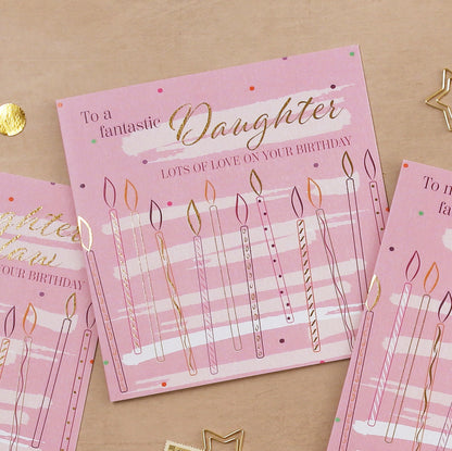 Pink birthday card for a daughter with candles and text on a beige background