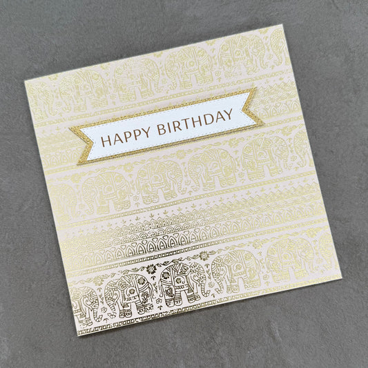 Greeting card with elephant pattern and 'Happy Birthday' text on a gray background