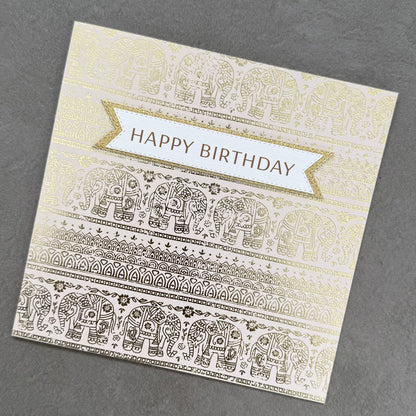Birthday card with gold and white elephant patterns on a gray background
