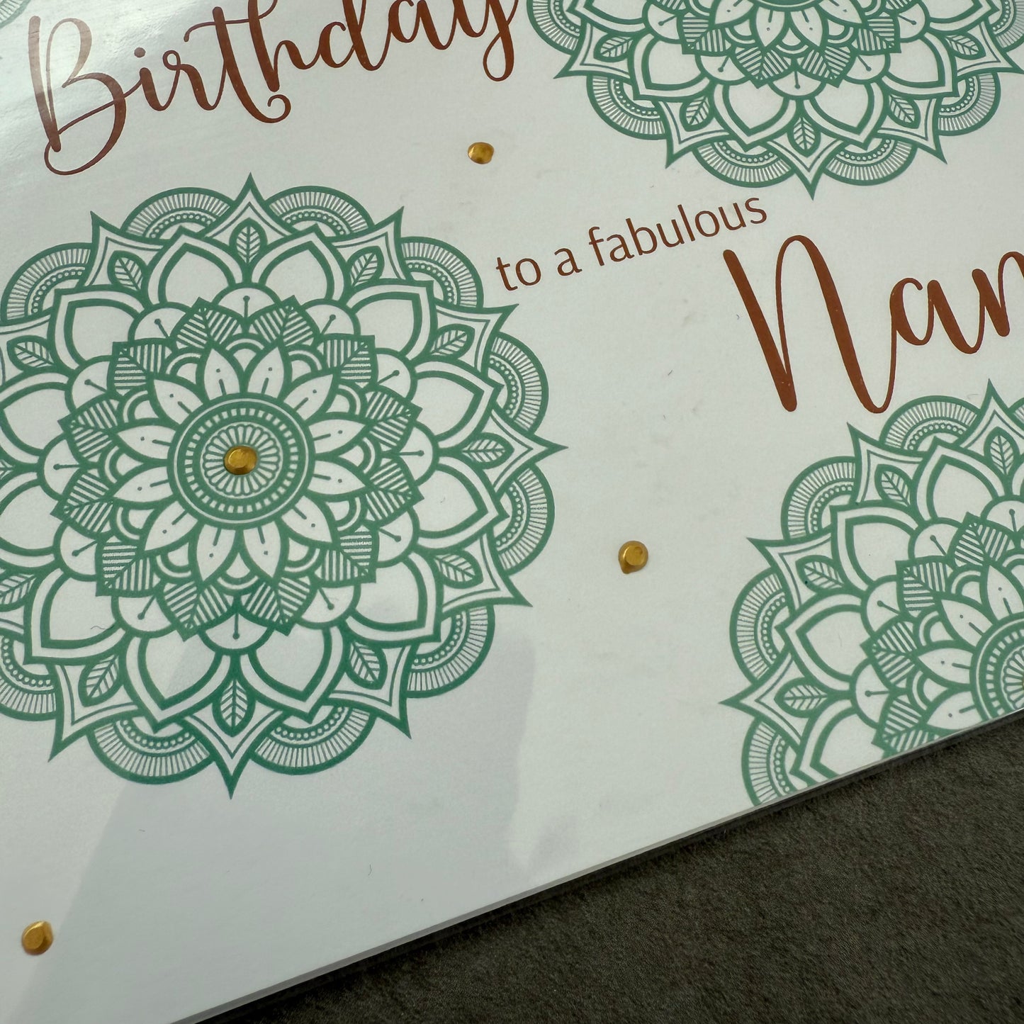 Greeting card with green mandala designs and text on a white background