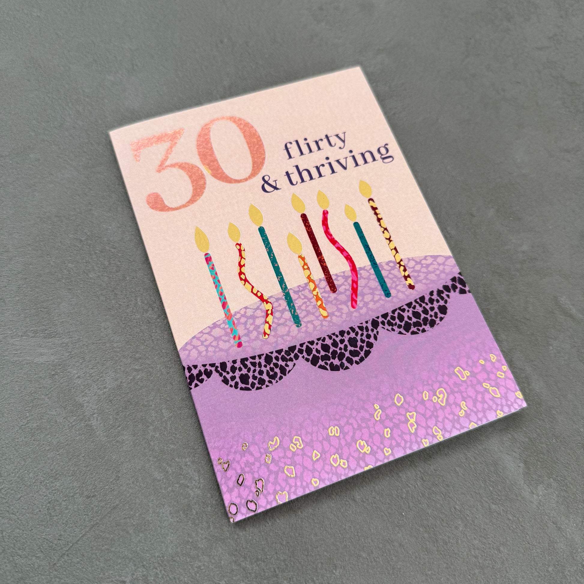 Greeting card with birthday cake design and candles on a gray background