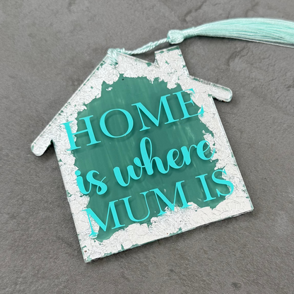 Decorative house-shaped sign with 'Home is where Mum is' text on a gray background