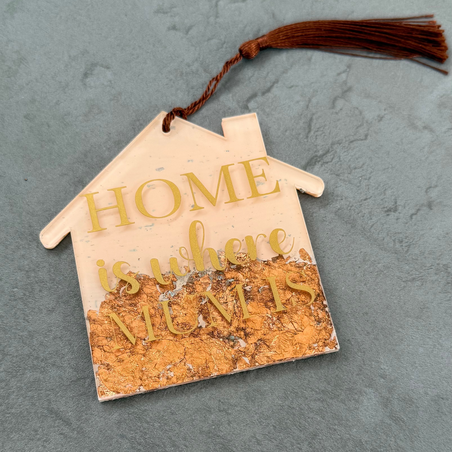 Decorative house-shaped sign with 'HOME is where MUM is' text on a gray background