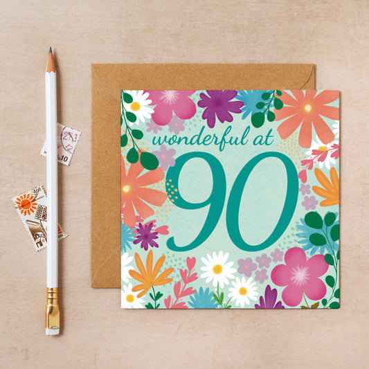 Greeting card with floral design and 'wonderful at 90' text on a beige background