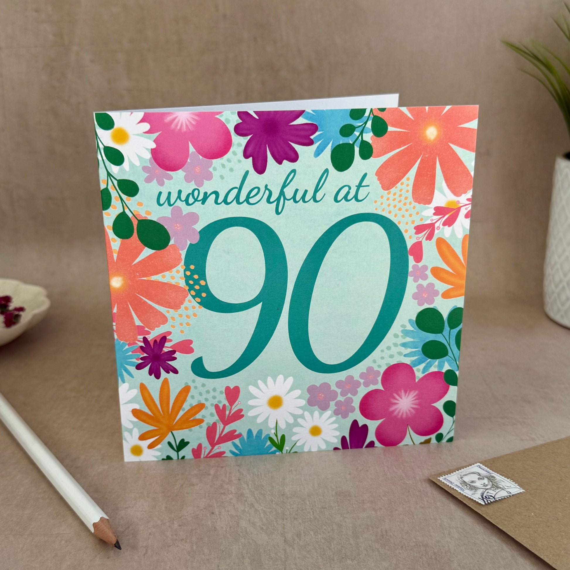 Floral birthday card with 'wonderful at 90' text on a neutral background