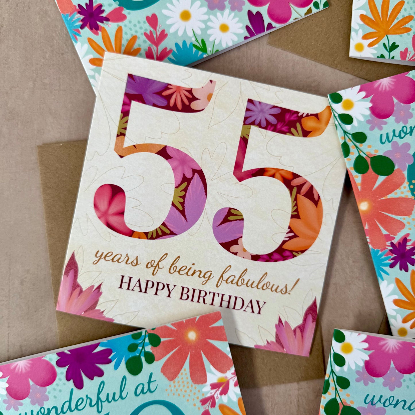 Colorful birthday cards with floral designs and numbers on a brown background