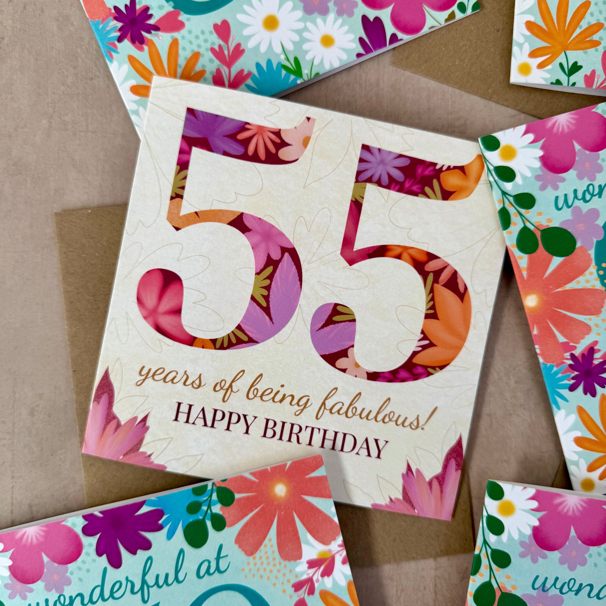 Colorful birthday cards with floral designs and numbers on a brown background