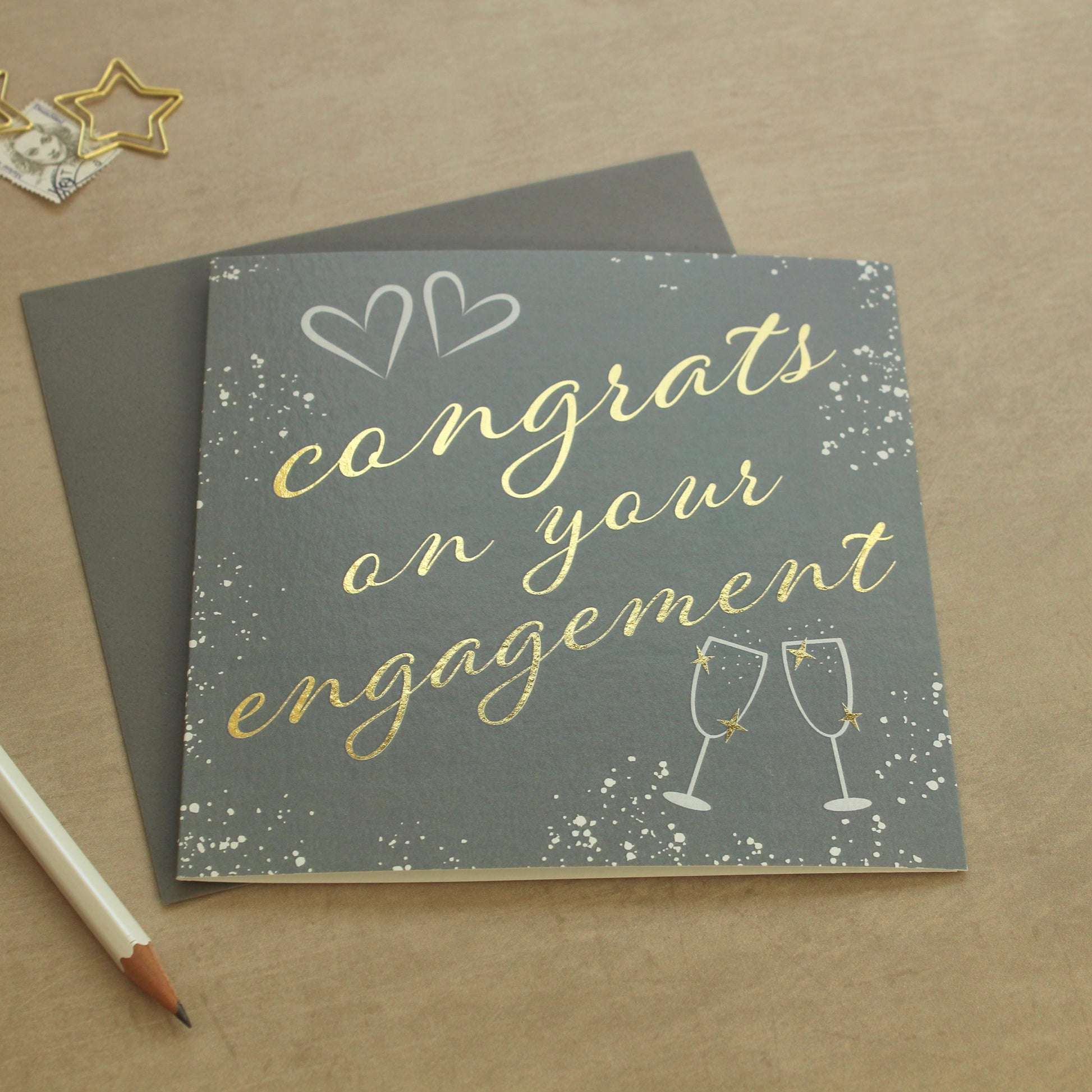 Card with 'Congrats on your engagement' text on a brown background
