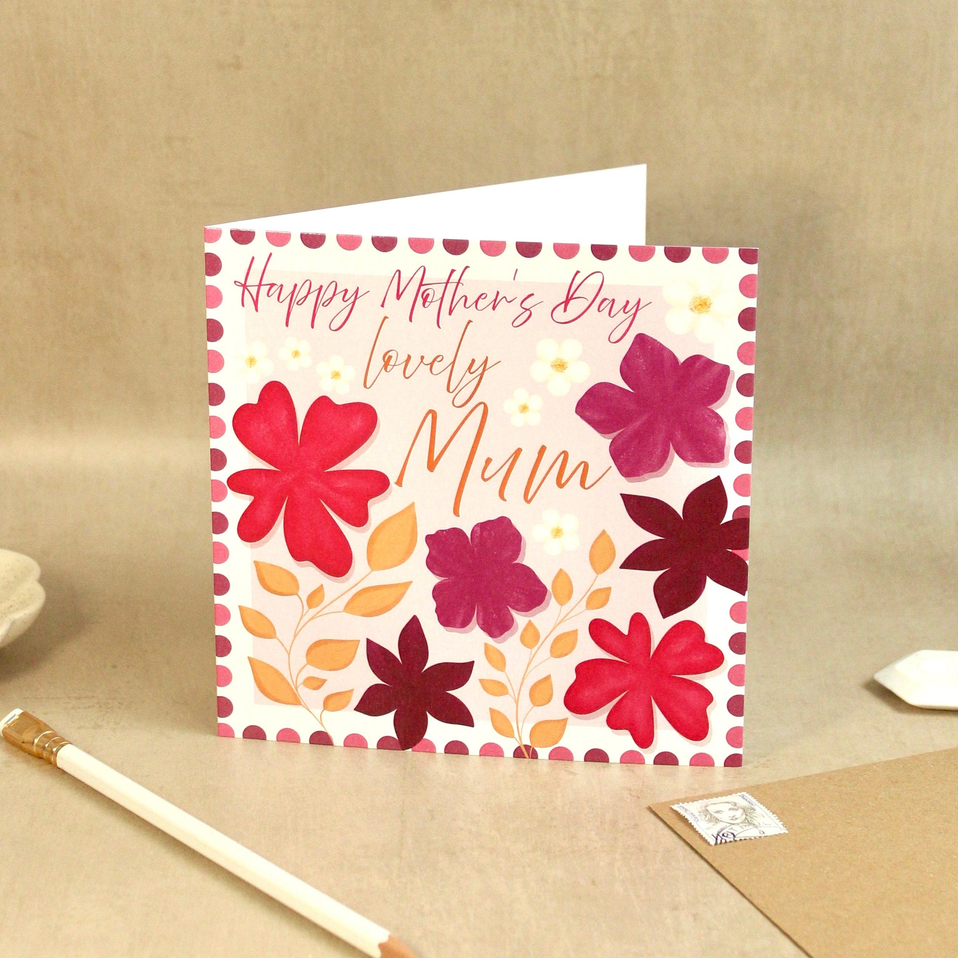Greeting card with floral design and 'Happy Mother's Day, Lovely Mum' text on a beige background