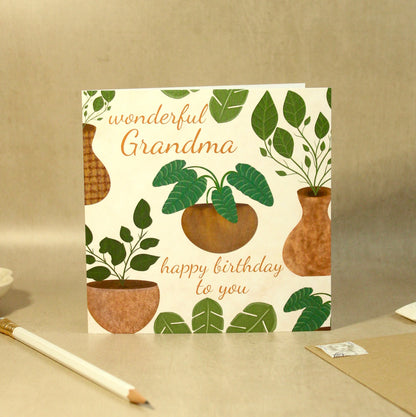 Greeting card with plant design and text on a beige surface
