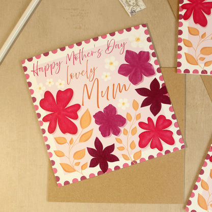 Greeting card with floral design and 'Happy Mother's Day, lovely Mum' text on a brown envelope.