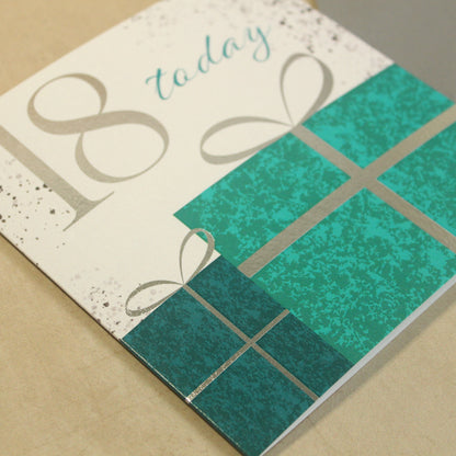Greeting card with teal present design and '18 today' text on a beige background