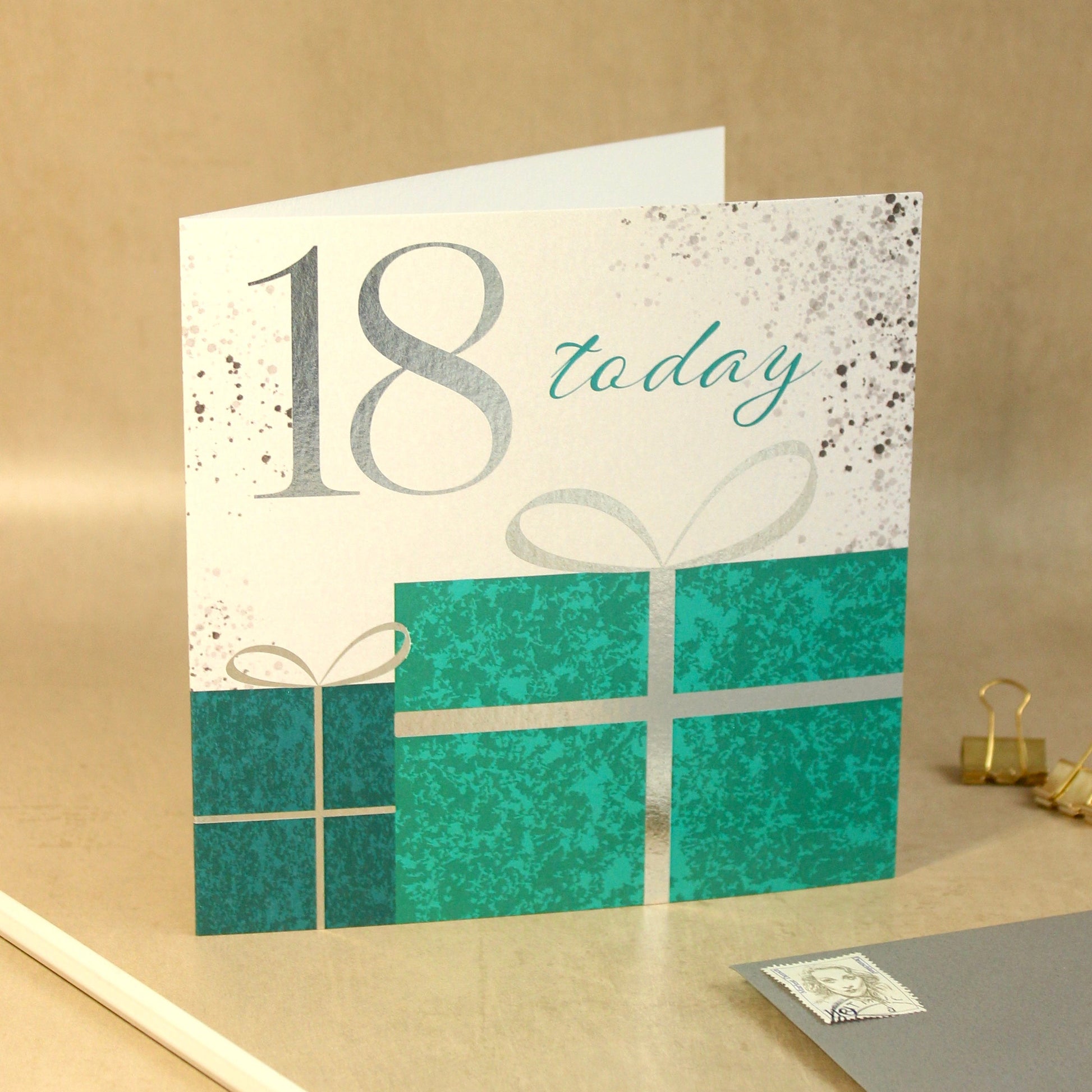 18th birthday card with teal presents on a beige background