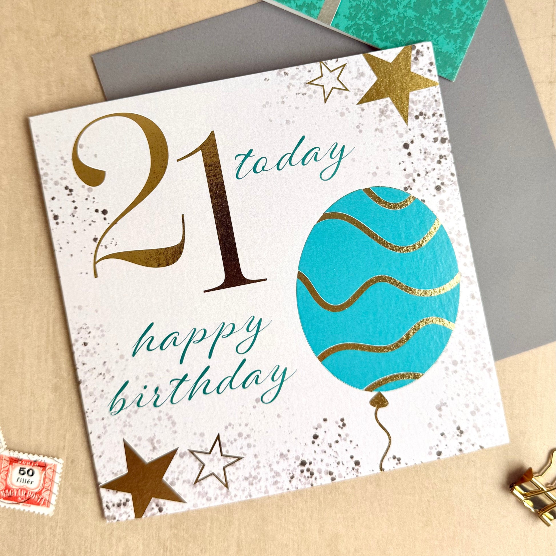 Birthday card with '21 today happy birthday' text and decorative elements on a textured surface.