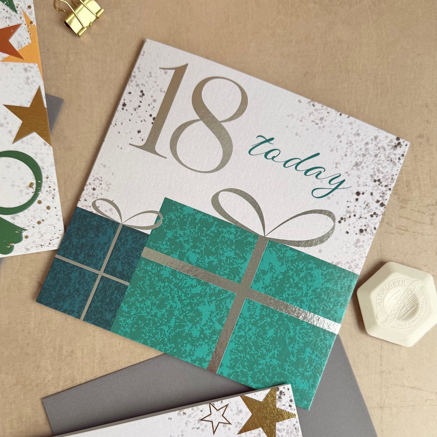 Two birthday cards with numbers 18 and 21 on a textured surface.