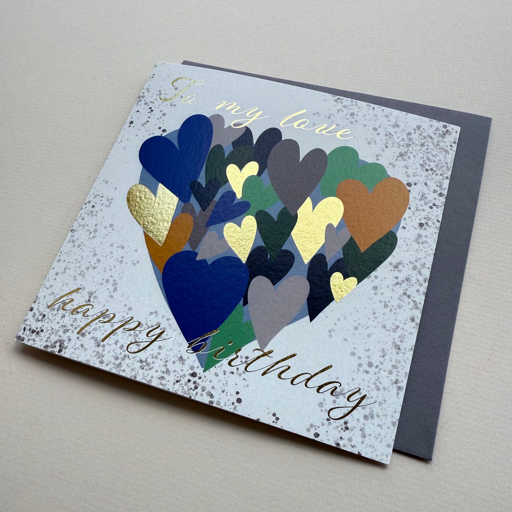 Greeting card with colorful heart design and 'Happy Birthday' text on a gray background