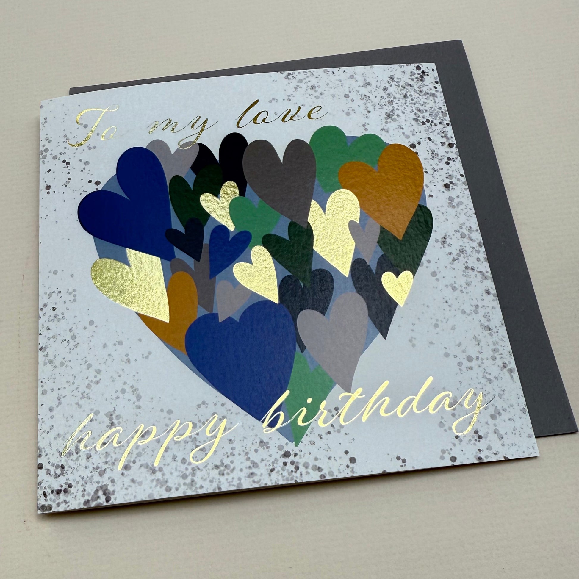 Greeting card with colorful heart design and 'Happy Birthday' text on a gray background