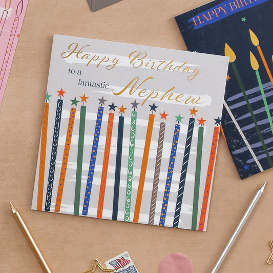 Birthday card for a nephew with colorful candles on a wooden surface
