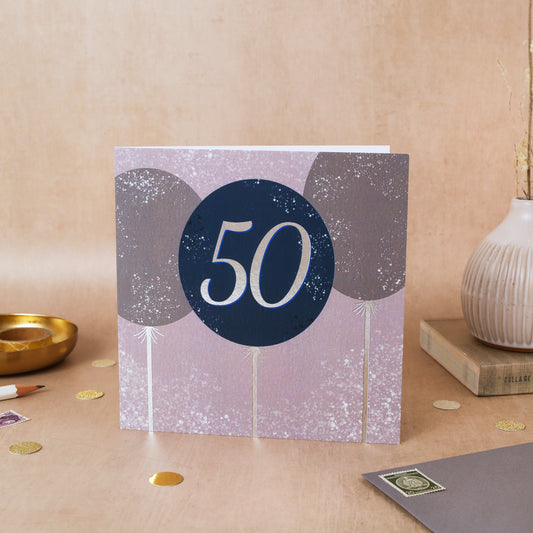 Greeting card with '50' design on a decorative surface with foiled finishing 