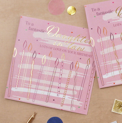 Collection of birthday cards for different family members on a brown surface.
