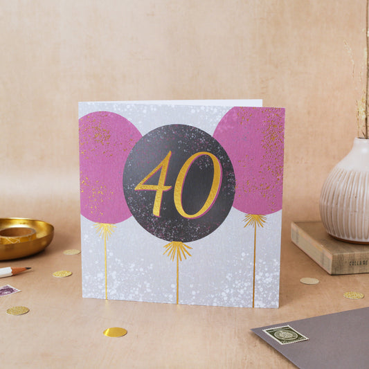 Greeting card with pink balloons and the number 40 on a beige background