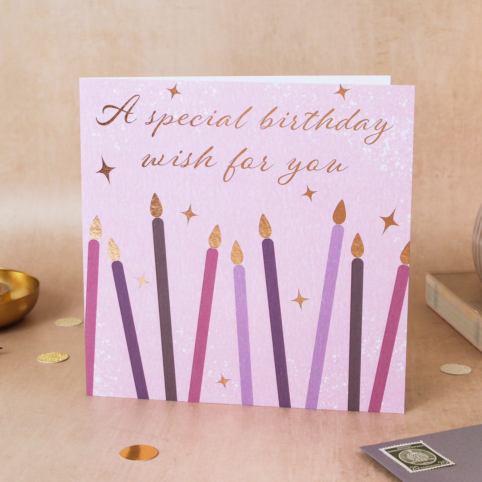 Birthday card with candles on a wooden surface