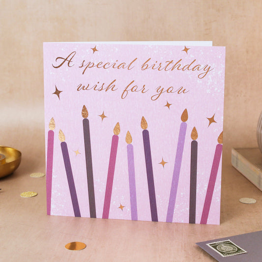 Birthday card with candles on a wooden surface