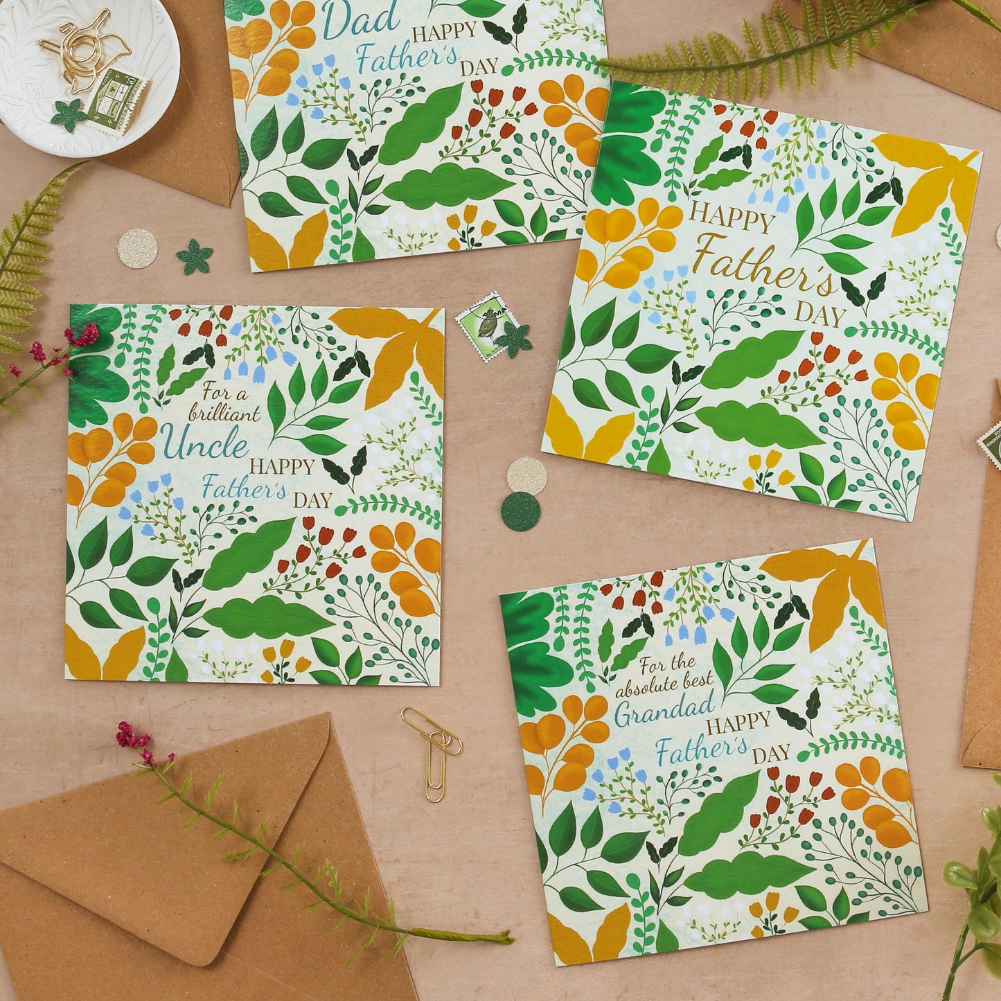 Colorful Father's Day cards with envelopes on a wooden surface.