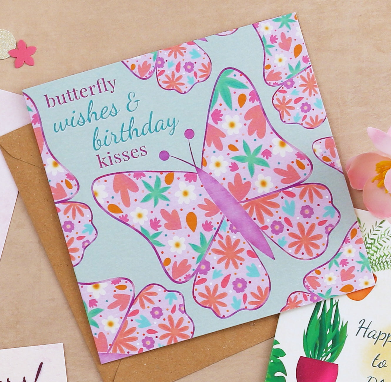 Butterfly-themed birthday card with floral patterns on a beige background