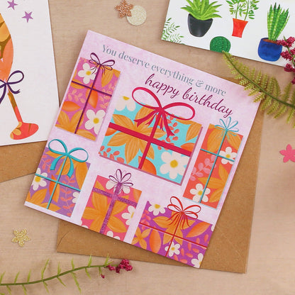 Colorful birthday card with gift designs and text on a brown background