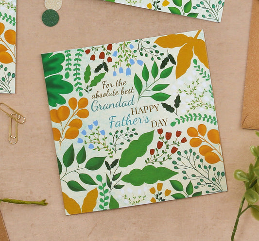 Father's Day card with floral design and text on a beige surface