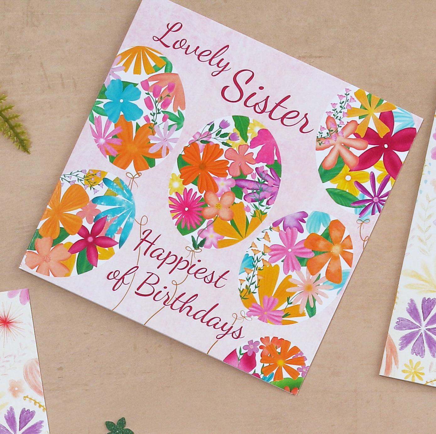 Colorful birthday card for a sister with floral designs on a beige background