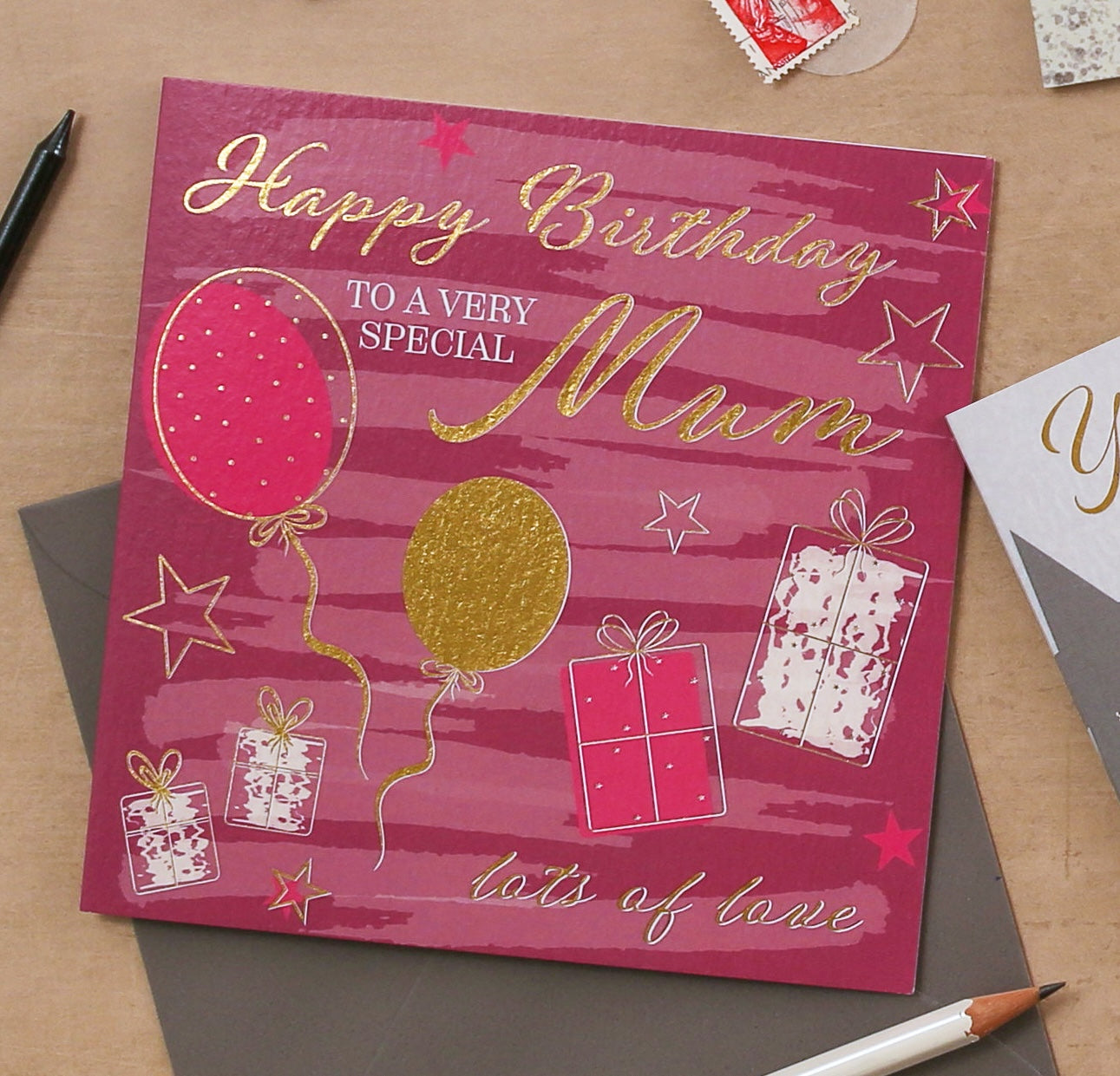 Birthday card for a very special mum with balloons and presents on a pink background